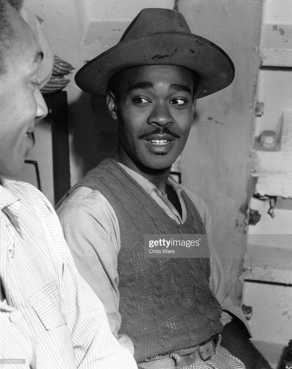 Melton Thompson, a Jamaican immigrant, takes a well earned rest after his days work in his small room at the Clapham shelter in London, 1948. Photo by Chris Ware