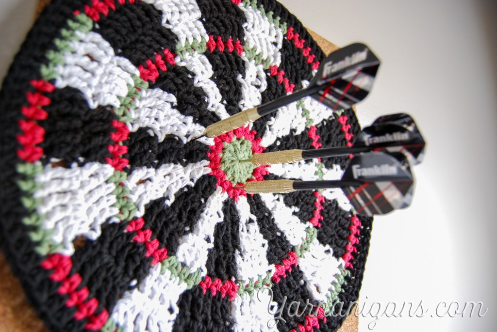 Crochet a Dartboard Mandala - I have an oldie, but a goodie for you today from my previous blog! It's a take on a traditional circle mandala but by using different colors placed strategically on the mandala, it resembles a… yarnanigans.com/crochet-a-dart…