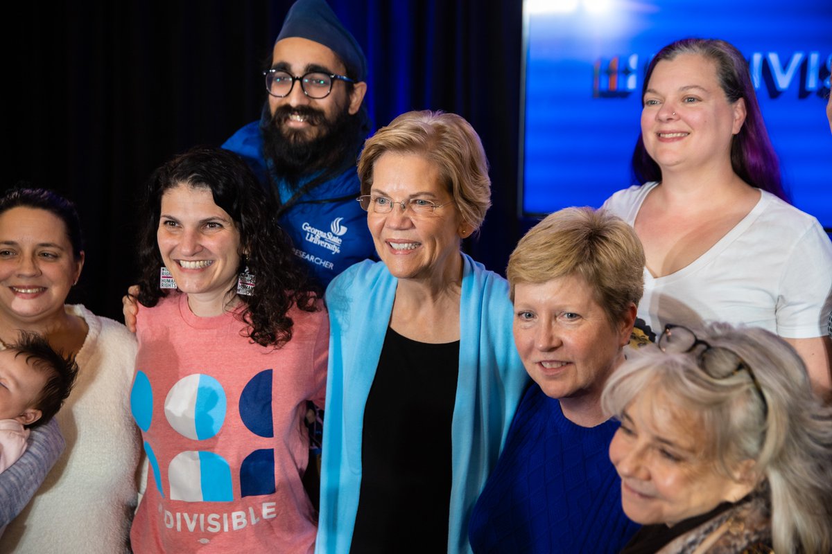 Elizabeth Warren and Indivisible supporters pose for a photo.