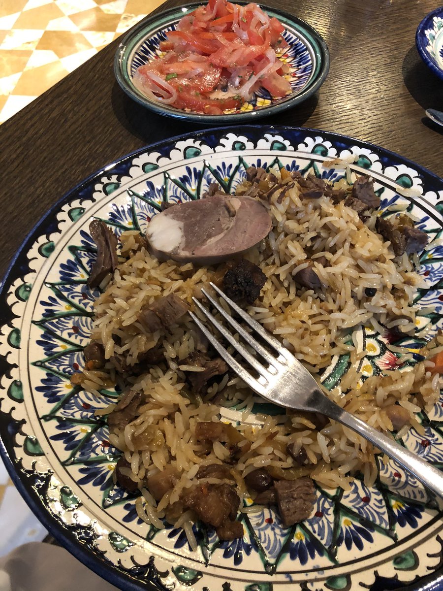 Tara_Deshpande's tweet photo. Lipsmacking good Plov in Tashkent. The Uz rice is v different from our biryani rice. Sticky and chewy has fabulous texture. They add raisins pumpkin and carrots too. Served with a tomato onion salad https://t.co/oFutfJZDb4