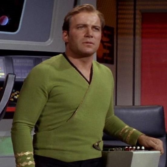 Why is Captain Kirk wearing a green wraparound tunic?As the costumes changed fabrics, how they appeared when film changed. Supposedly, the pullovers were also greenish. (But that doesn't make sense with the rank gilding around the neck?)