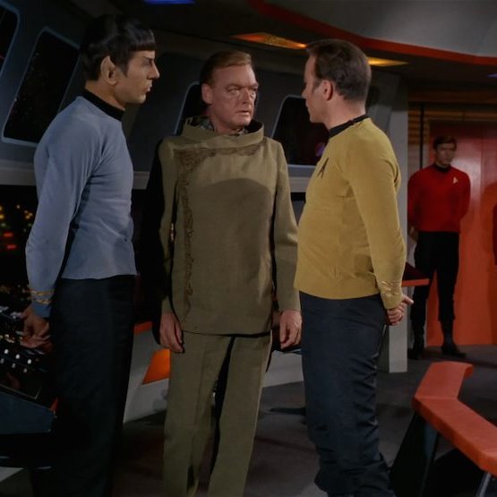 Ambassador Fox is not in Star Fleet, but he is a Federation official, a sort of State Department civil servant.While horribly bland earth tone, its not a bad outfit. In fact, its got similarities to the Wrath of Khan uniforms