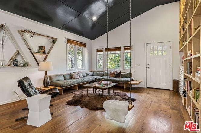 Look at this amazing cottage with its dark grey exterior and glossy black cathedral ceiling and weird swing thing and cool floor-to-ceiling custom bookshelf. I feel uncool just looking at it because this house is so much cooler than me.It's asking $4.65M  https://www.redfin.com/CA/Venice/812-Amoroso-Pl-90291/home/6743703