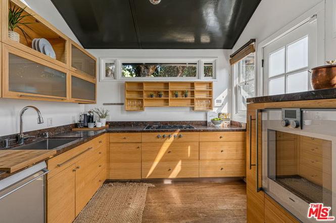 Look at this amazing cottage with its dark grey exterior and glossy black cathedral ceiling and weird swing thing and cool floor-to-ceiling custom bookshelf. I feel uncool just looking at it because this house is so much cooler than me.It's asking $4.65M  https://www.redfin.com/CA/Venice/812-Amoroso-Pl-90291/home/6743703