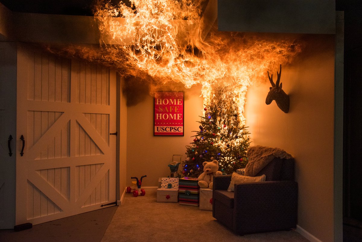A Christmas tree burning dramatically in a living room. Keep your tree well watered this holiday season.