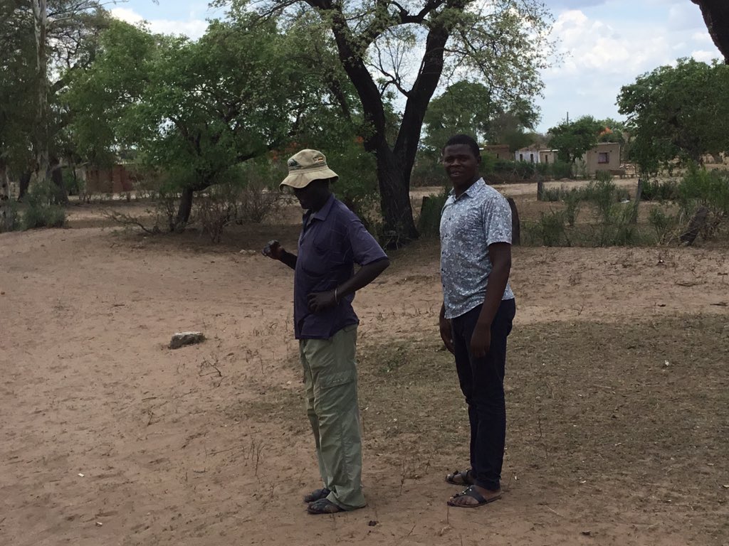 ...totem, bellowed the Headman. So whose child is your daughter, I shot back, mane standing on end. Aaaah!! In verandah hat, Sabhuku Madhuku, with a youngster from the area. In red, male store worker who thinks only girls go away. The other bloke is Jamwanda. Enjoy!