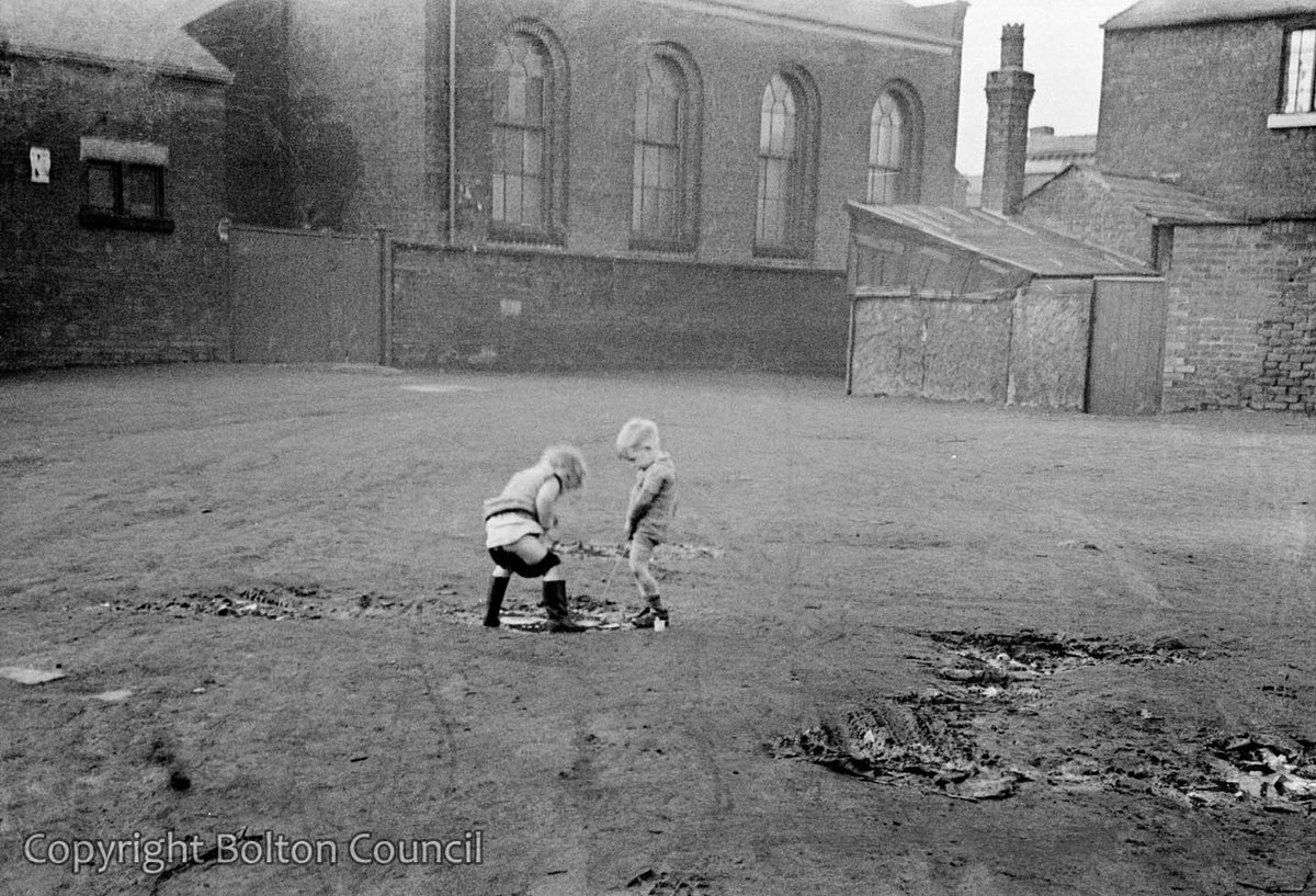 The Art of Album Covers ..Two boys peeing on wasteland by Ellesmere St in Farnworth, 1938.Photo by Humphrey Spender..Used by Everything but the Girl on the cover of their album ‘Love not Money’, released 1985.