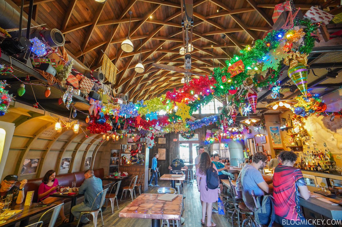 Blog_Mickey's tweet photo. FIRST LOOK! Jock Lindsey’s Hangar Bar Holiday Overlay and Decor Debuts at Disney Springs 

All photos: https://t.co/lrZPJNrUkI https://t.co/vbk8ykUmew