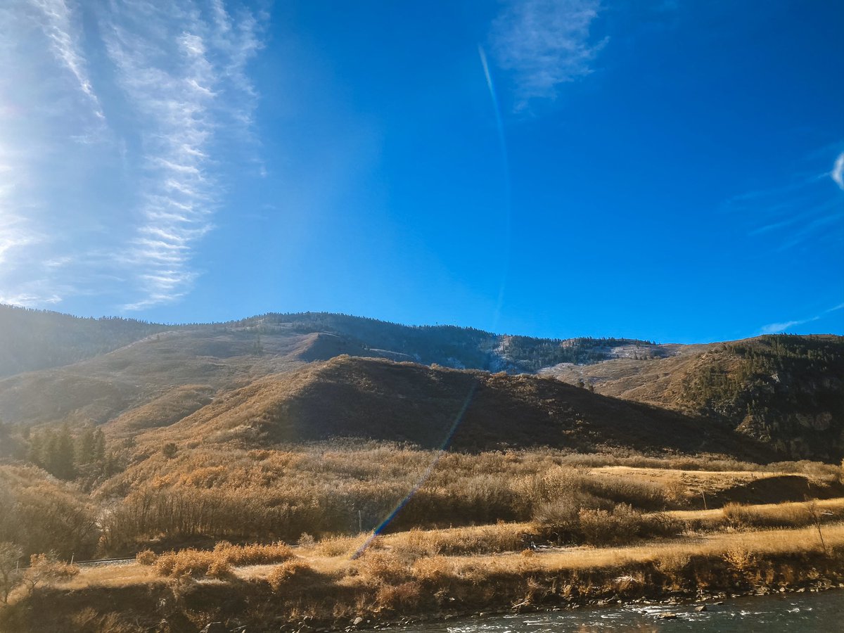 Landscape of golden brown mountains with a vibrant blue sky