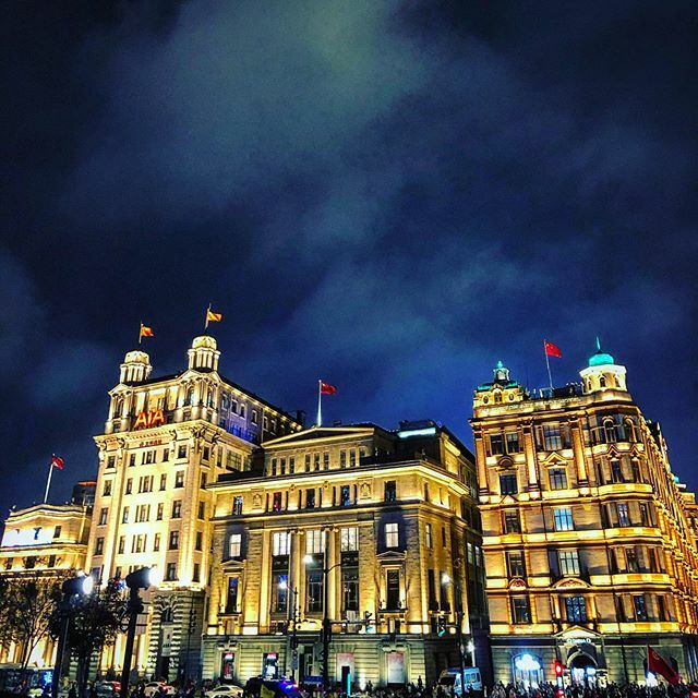 Walking the Bund at night in Shanghai, seeing the colonial architecture lit beautifully