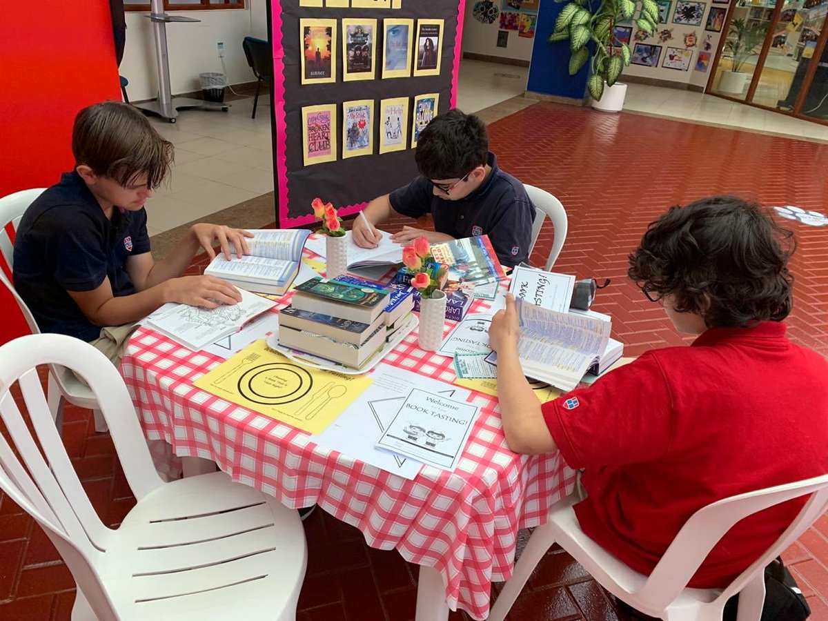 Grade 7 students tasting a French book in a Reading cafe at CAS!