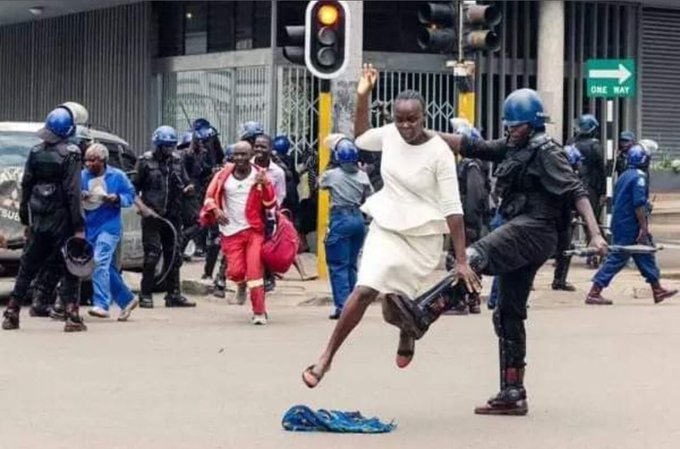Zim riot cop trips up a running woman