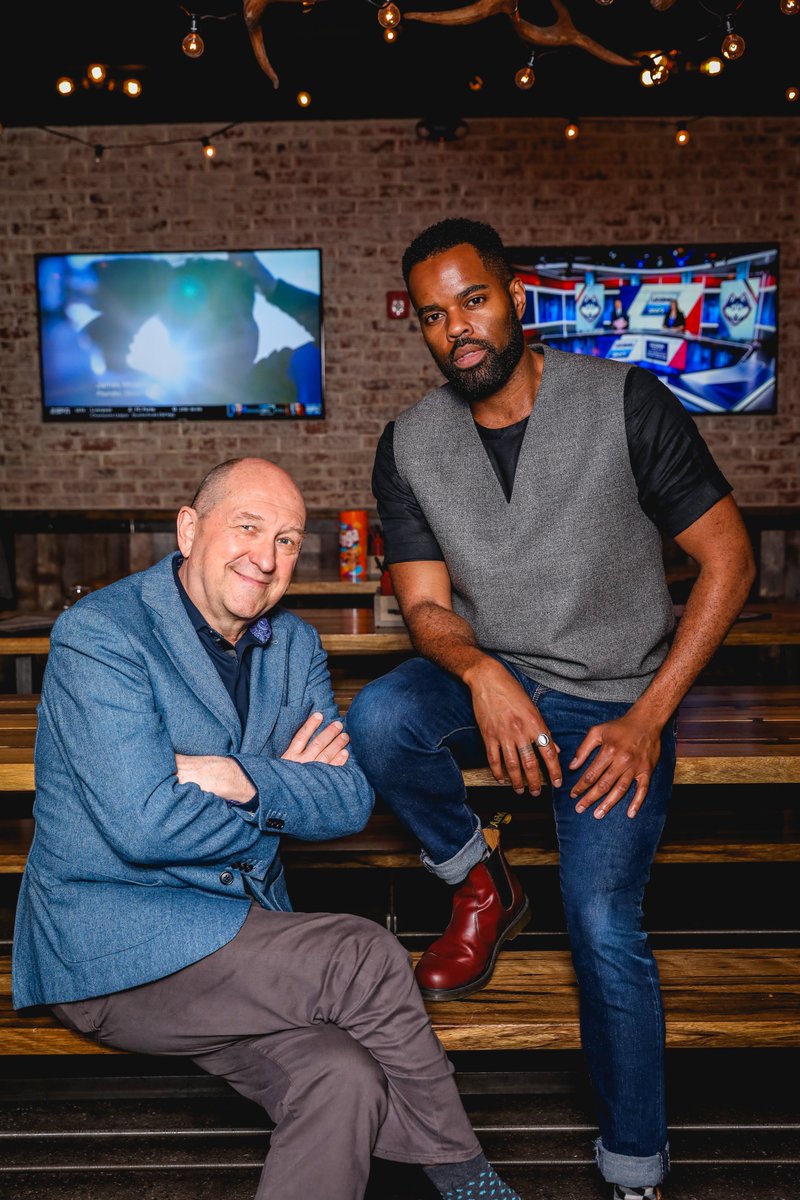 A photo of De'Lon Grant and Joel Hatch sitting at a table 