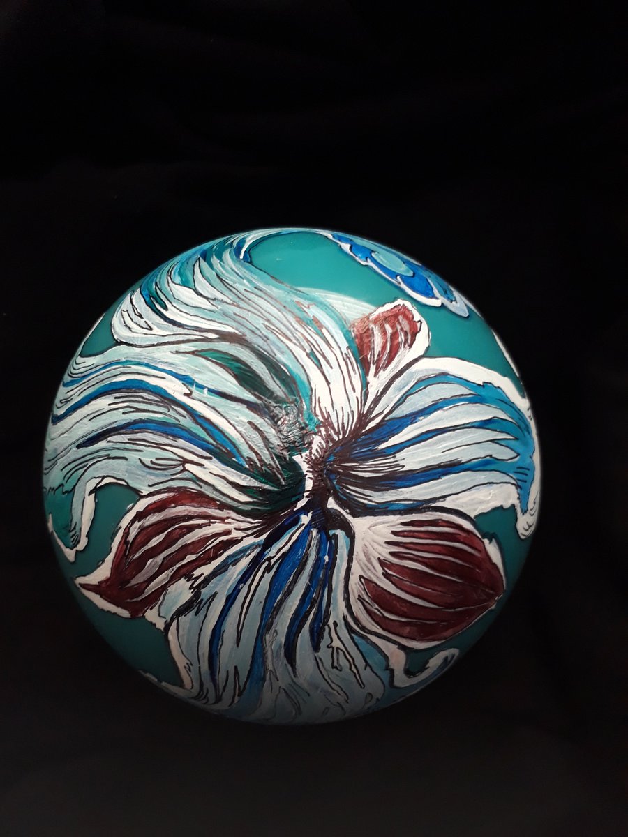orchid-like flower of white blue and red, painted on a teal background