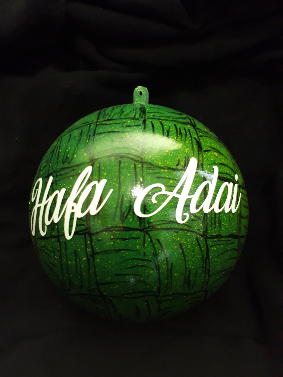 Hafa Adai, a greeting in Guam, is written in cursive in white over a green and black background