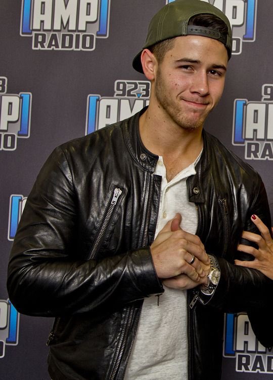 Nick Jonas in a backwards ballcap