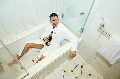 Nick Jonas in a bathtub