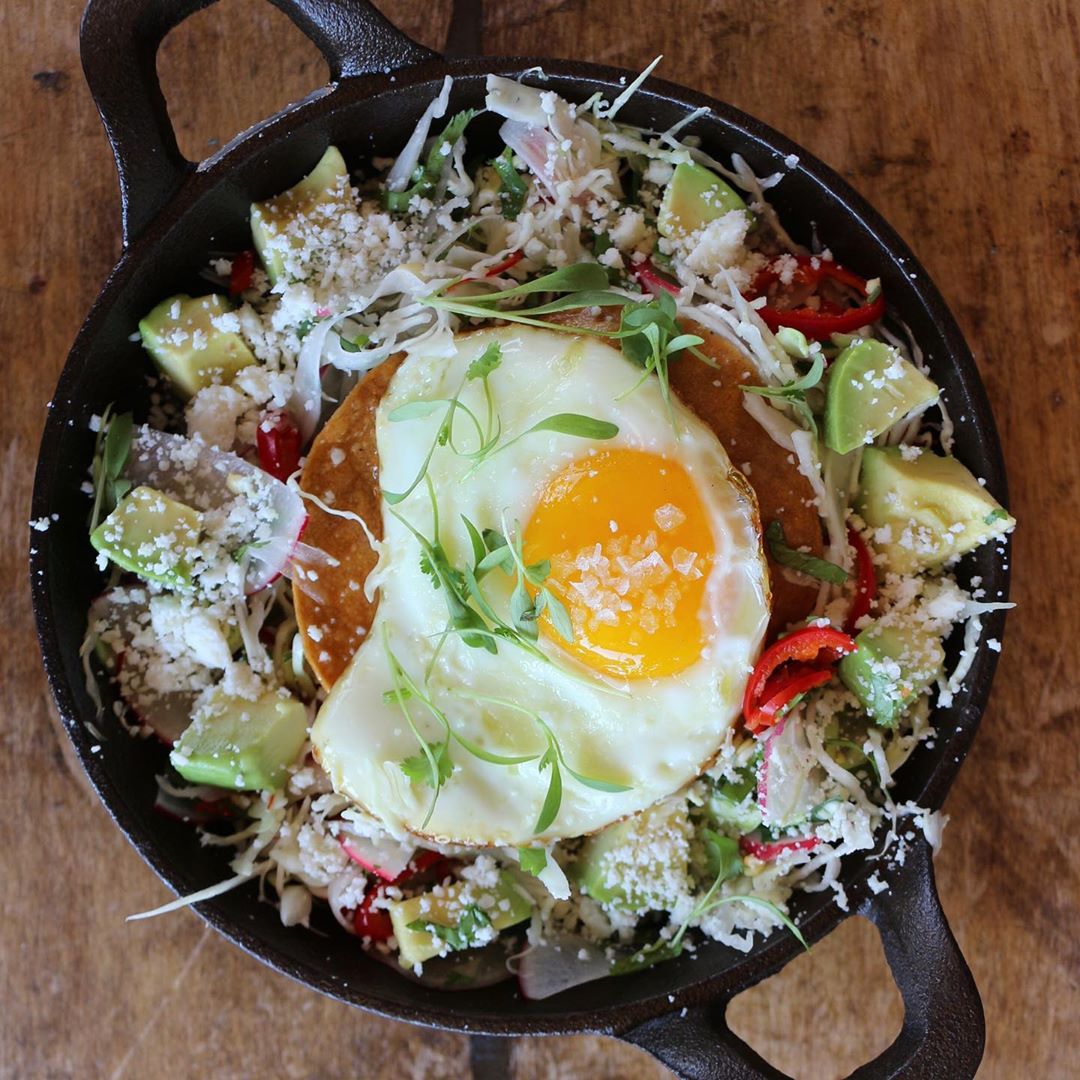 Chilaquiles with carnitas, black beans, Fresno pepper, cabbage, avocado &amp; cotija.