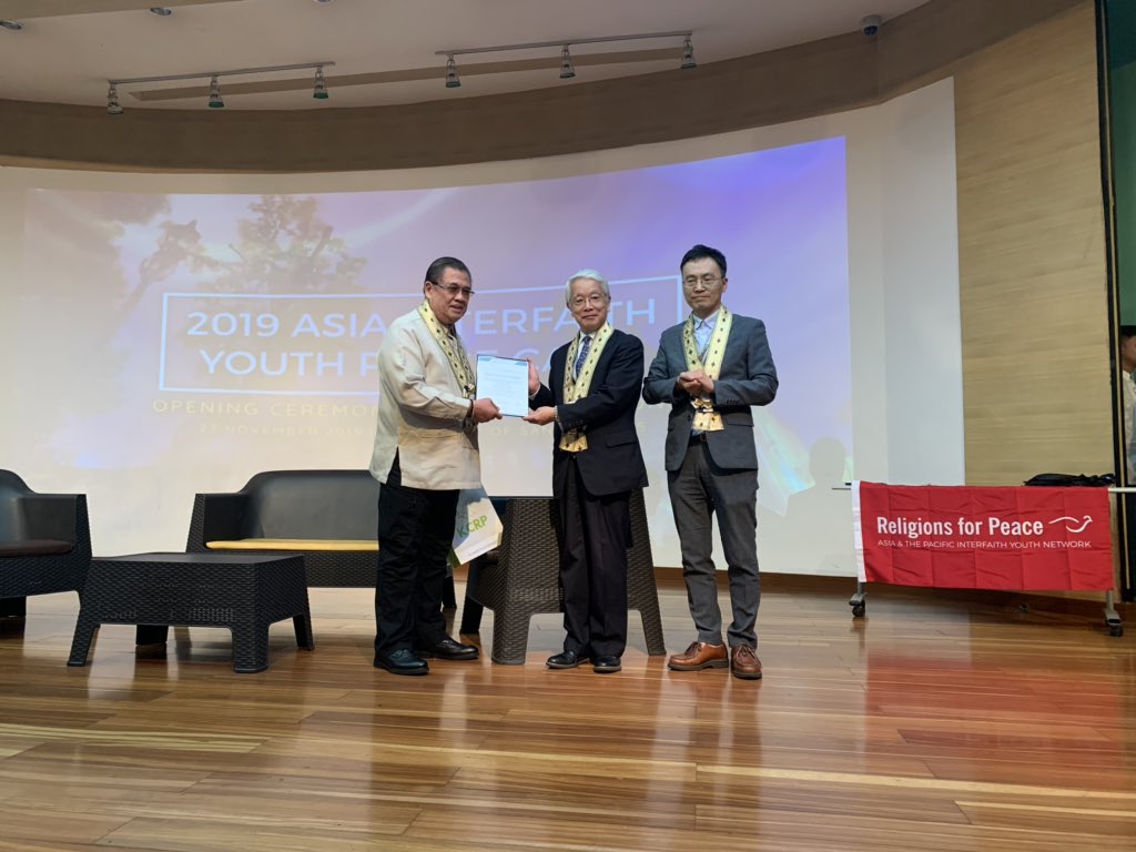 rfp_apiyn's tweet photo. Our keynote speaker, the honorable secretary Abdullah Mama-O, being awarded by Rev. Taehyon Kim and Rev. Masamichi Kamiya. #RfPAPIYN2019 #APIYNxUST https://t.co/P9CvfYYRlg