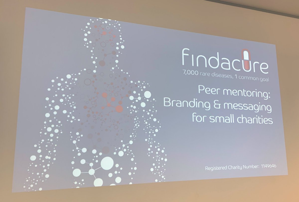 Photo of a presentation screen with the findacure logo on and title of the event: Peer mentoring training - branding and messaging for small charities