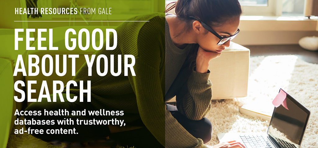 a woman sitting on the floor looking at her laptop