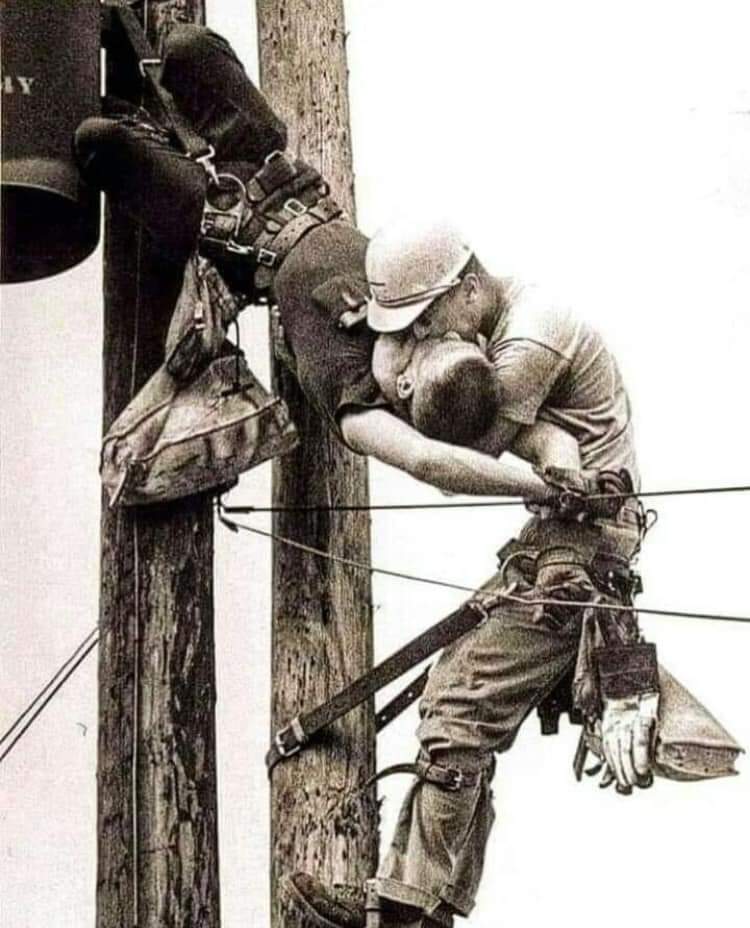 THE KISS OF LIFE.This is not a picture of two gay men kissing.Thread..This award-winning 1967 photo, taken by Rocco Morabito, was titled "The Kiss of Life." It shows two electrical operators, Champion Randall and JD Thompson, on top of an electricity pole.