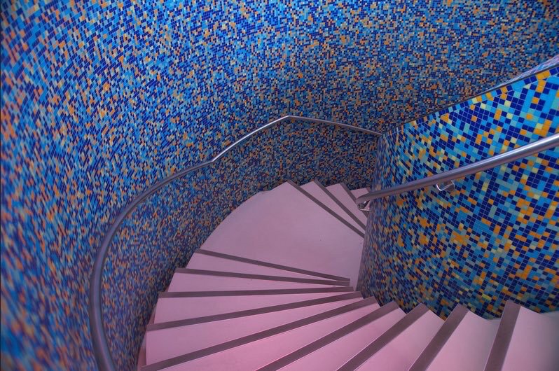 This is the central spiral staircase inside  Mendini sometimes polemically, wildly dissolved forms through a pontilist use of granular colourStairs in the Groninger Museum, Alessandro Mendini, 1990-4Photo by fototon2010 on Flickr