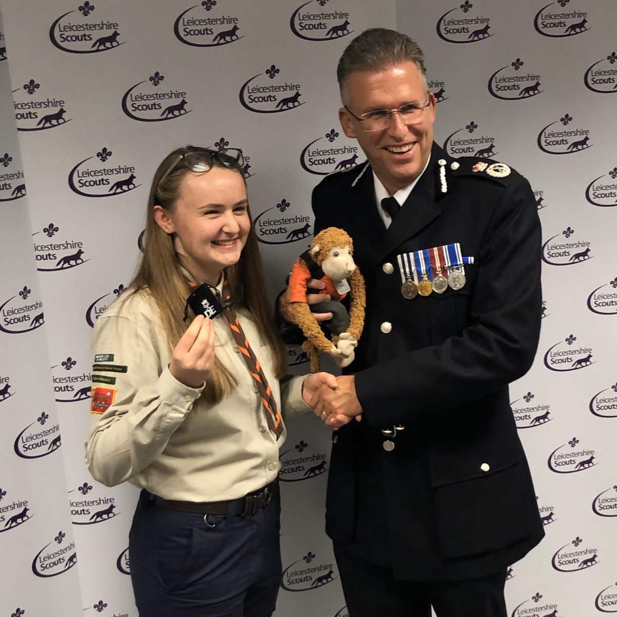 MonkeyPhill's tweet photo. An evening celebrating the achievements of @LeicsScouts - Young Leader Belts, #DofE and a Queens Scout Award. Well done everyone! Here’s a picture of Phoebe and me with @CCLeicsPolice. I’ve supported Phoebe through much of her #DofEGold journey. #mascot #bandarlog #thescouts https://t.co/BLhEGPEgDM