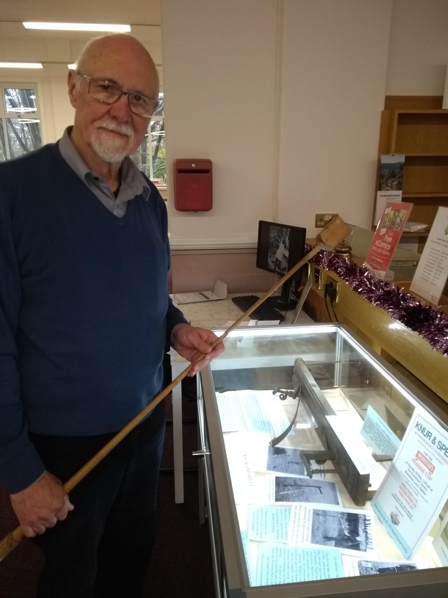 CMBClibraries's tweet photo. Sowerby Bridge Library. Here is a photo of Gary, our local history volunteer, setting up a display about the game of Knurr and spell. It will be on for 6 weeks. #cmbclibraries #localhistory https://t.co/2PtJ32Gikj