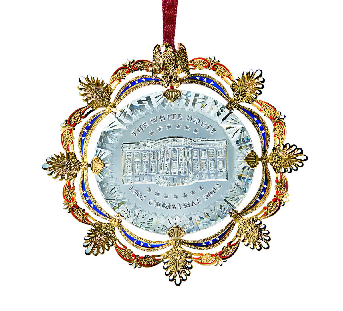 The 2002 ornament features a crystal-like acrylic core, inspired by the sparkling chandeliers of the 1902 East Room. The decorative frame has acanthus leaves and an eagle, elements of the East Room after the Roosevelt redecoration.Make your room sparkle:  https://shop.whitehousehistory.org/holidays/ornaments/the-2002-white-house-christmas-ornament-east-room-motifs-celebrating-the-centennial-of-the-1902-redecoration