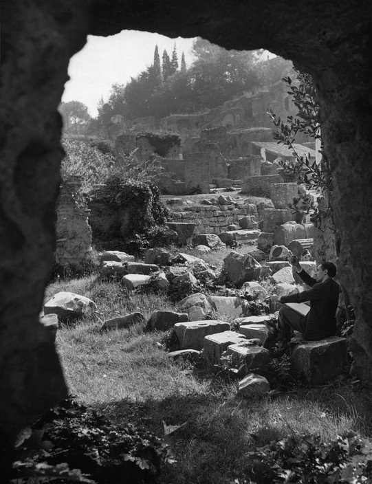 A draughtsman sits among the ruins of the Roman Forum, seeking to capture the irretrievable, 1949 photograph by Herbert List.