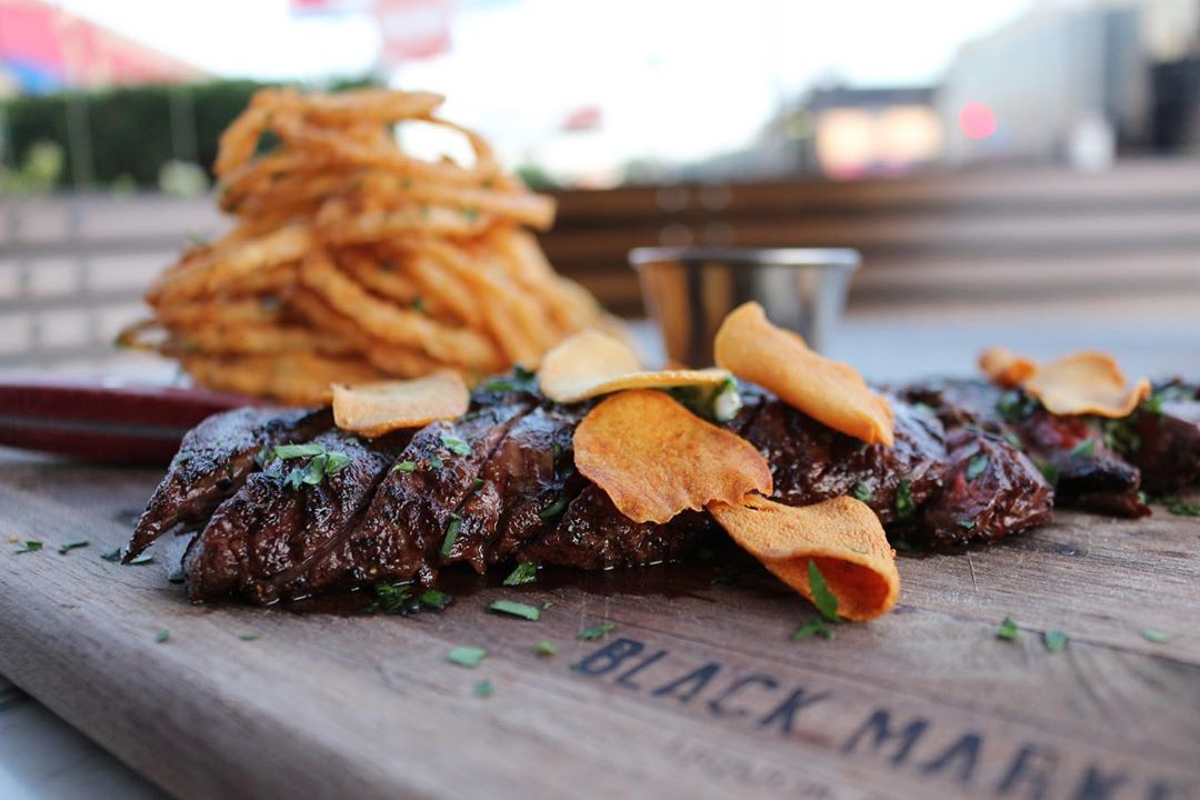 Escape the cold tonight with our Charred Skirt Steak with crispy onion, mustard aioli, parsley &amp; garlic chips.