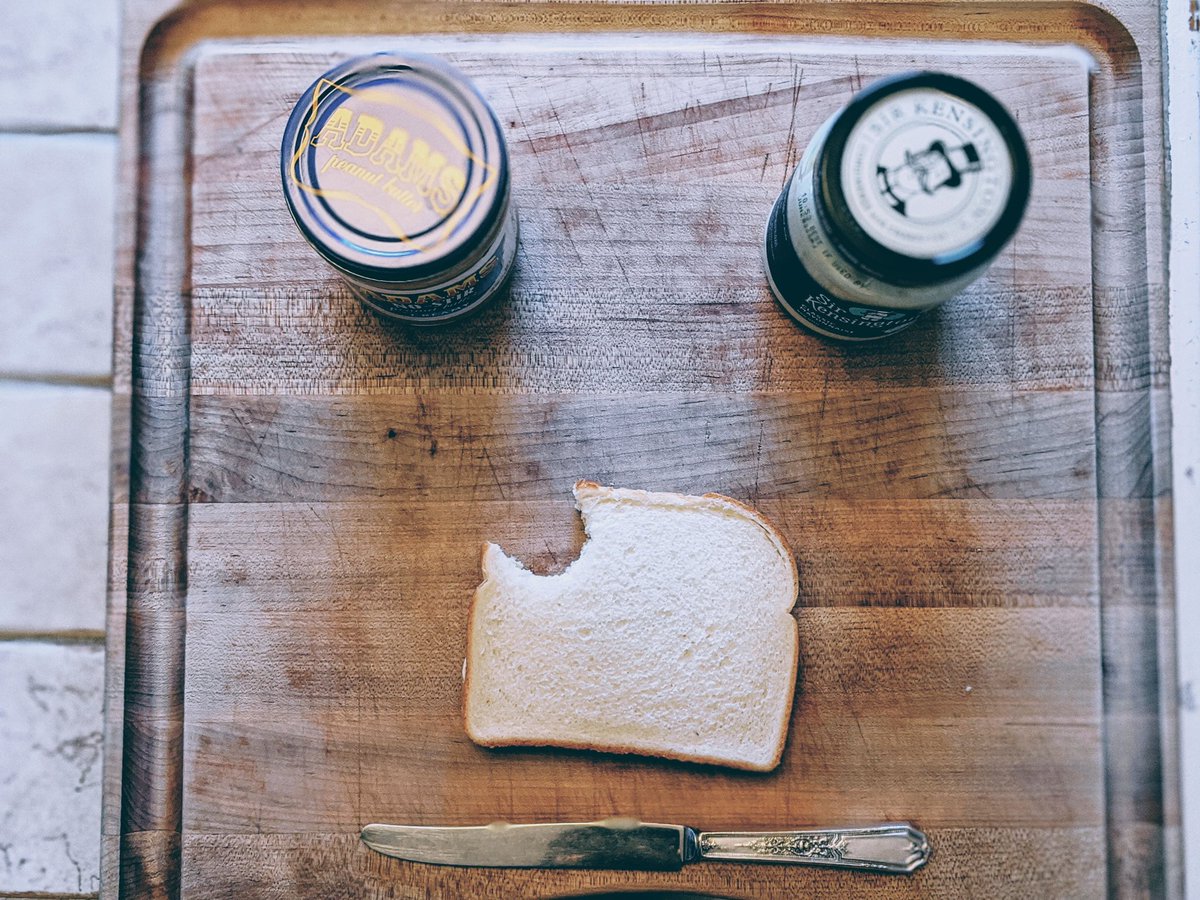Both pieces of bread together as a sandwich with one bite taken out.