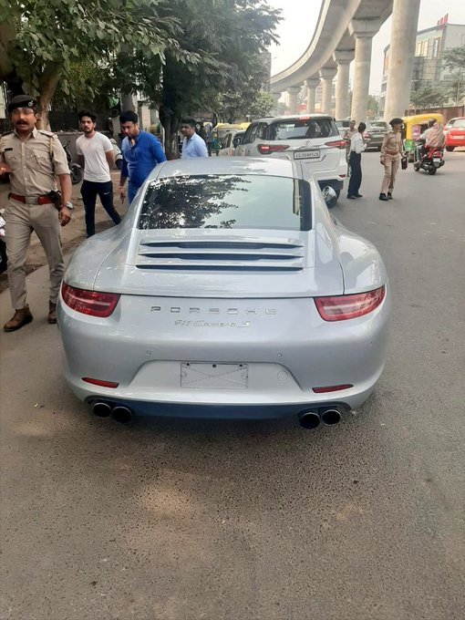 ANI's tweet photo. Ahmedabad Police detained a Porsche 911 car y'day and imposed fine of Rs 9.80 lakhs on owner. Ajit Ranjan, DCP,Traffic says,"We detained car as it did not have proper documents and valid number plate. Car was uninsured and earlier penalties worth over Rs 9 lakhs were unpaid." https://t.co/92vGwjHnCy