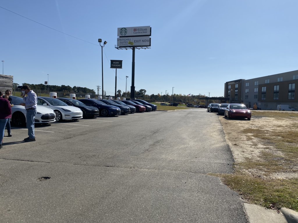 Meeting lots of happy <a href="/Tesla/">Tesla</a> owners at busy charging stations.  Best t-shirt was one that said “my other car is a reservation”.