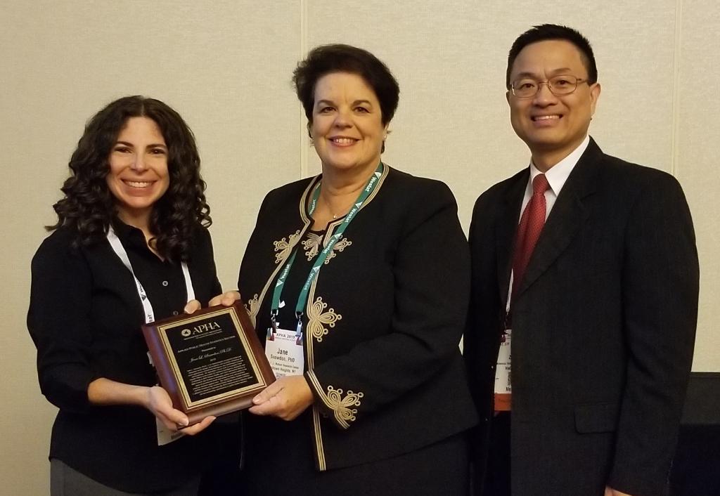 3 people holding award