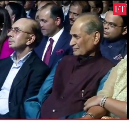 Who is this industrialist just behind Rahul Bajaj? (with specs)