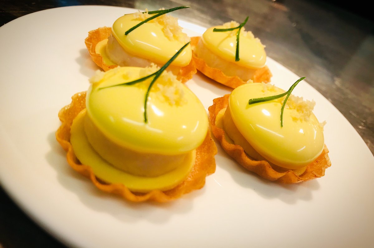 Omelette Arnold Bennett tartlets made with a warm scallop and smoked haddock mousse topped with hollandaise sauce and parmesan crumb.