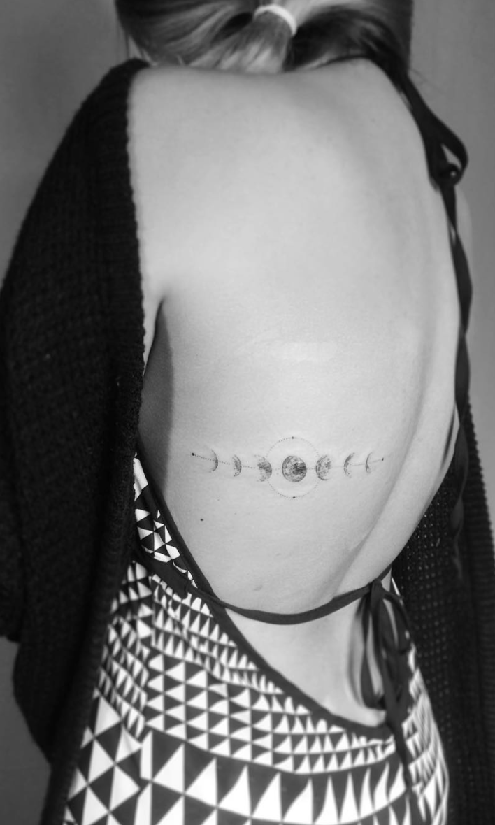 Minimalist moon phases tattoo on the wrist