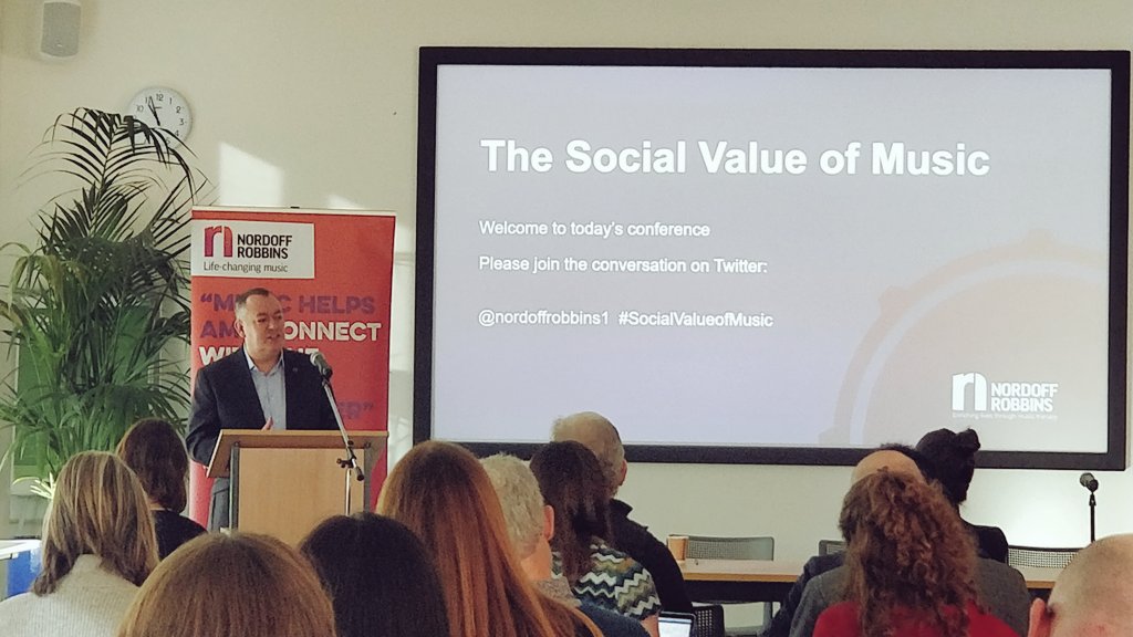 JohnMcArts's tweet photo. 'The huge economic value of music is absolutely inextricably linked to the #SocialValueOfMusic'

@MichaelDugher, CEO of @UK_Music, gives the opening keynote at the @NordoffRobbins1 conference in North London. https://t.co/JfkT0jEqTa