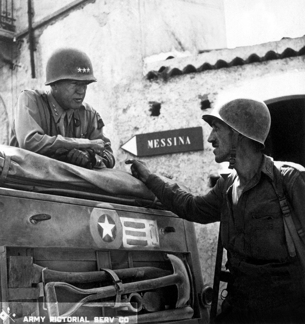 WW2Facts's tweet photo. Lt. Col. Lyle Bernard, CO, 30th Infantry Regiment, discusses military strategy with Lt. Gen. George S. Patton near Brolo, Sicily, in 1943. 

#History #WWII https://t.co/1Sn7wx5YBa
