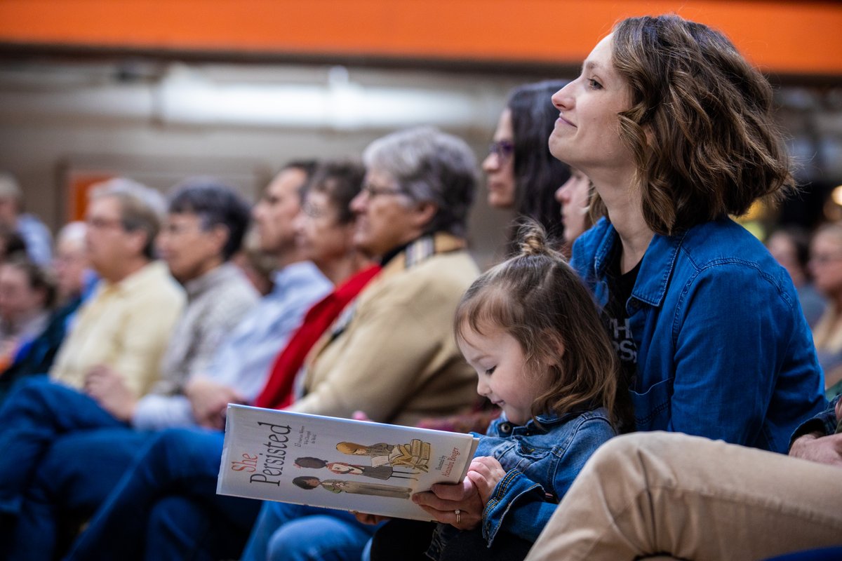 A young girl reads a book at the Washington town hall.