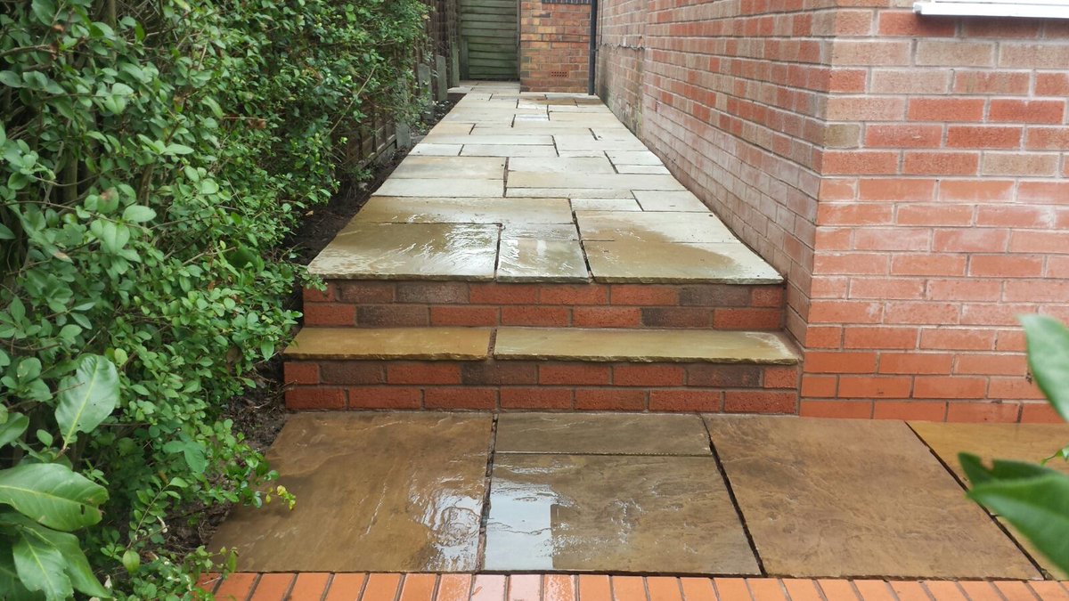 Hampton_Group's tweet photo. This Cotswold stone random paving perfectly suits the property as though it was there from the start! Could your outdoor space do with a tidy up? Contact us if you require the services of our landscaping team #hamptonconstruction #landscaping #sideentry #patio #randompaving https://t.co/kUViYO9XGj