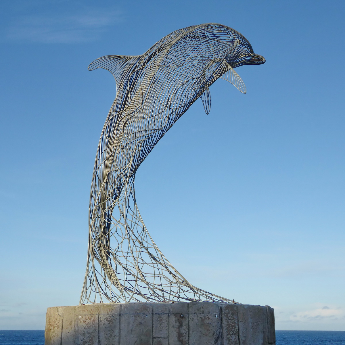 Sculptor Carn Stading's dolphin at Portsoy harbour. Today is a magnificent blue sky day perfect for exploring our Banffshire Coast.