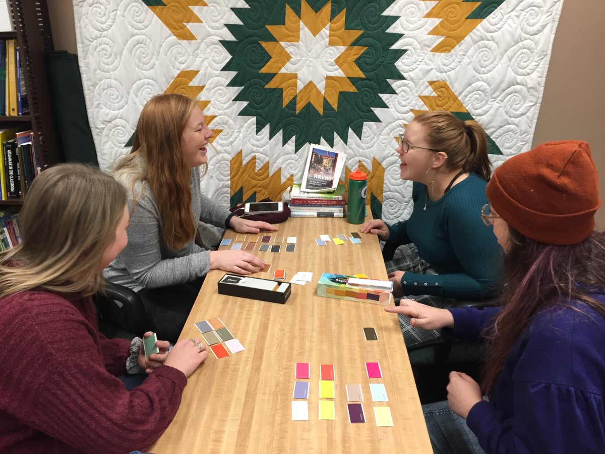 NdsuEnglish's tweet photo. NDSU English education majors Tylie Olson, Tanisha Topinka, Hannah Hirt, and Liberty Colling play a game of "Paint Chip Poetry" in the Red River Valley Writing Project office. #ndsuenglish #rrvwp #paintchippoetry https://t.co/hP9t7LaOpK