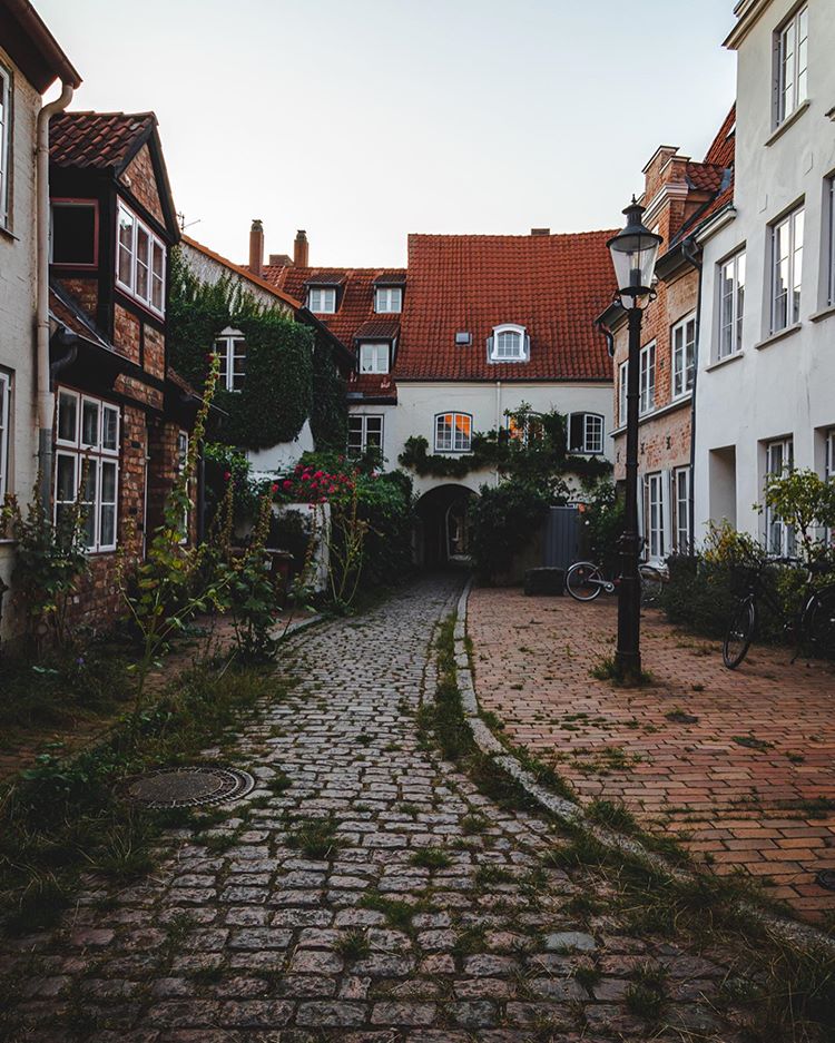  #GoodUrbanism means building squares and streets for the public in the front, and to balance the public areas with increased levels of privacy by secluded  #Courtyards, mews, backyards, hofs just a few steps from the busiest streets or liveliest squares.  #Lübeck  #Germany