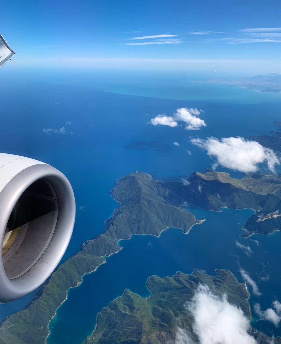 View of South Island NZ from the air, clear blue sky’s and water