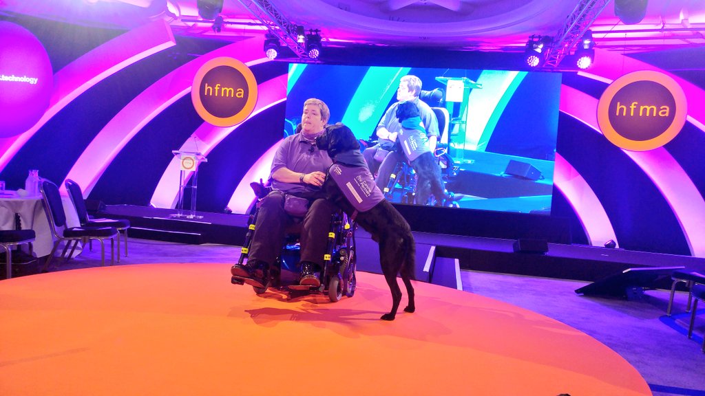 HFMA_UK's tweet photo. Now on stage we have the amazing Jax and @CpKingston007, the Super Dog. They are sharing their story and how #PersonalHealthBudgets changed Jax's life. #HFMA2019 #phbs https://t.co/gob4lPuppl