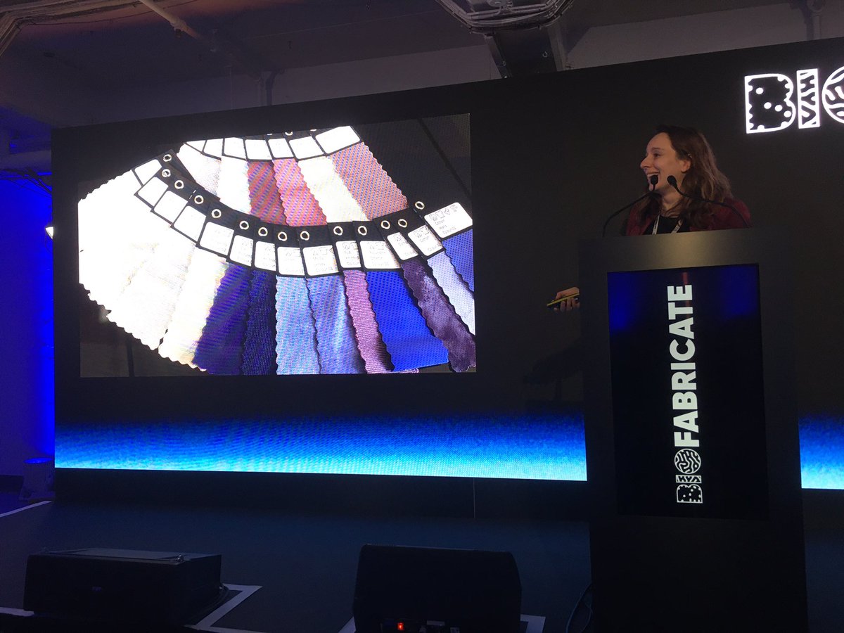 Biofabricate_'s tweet photo. Karin Fleck shows off beautiful samples from Vienna Textile Lab, made using biogenic dyes. We need to create entire production systems that are #sustainable, not just individual products #biofabsummit https://t.co/0nqub8IEOL