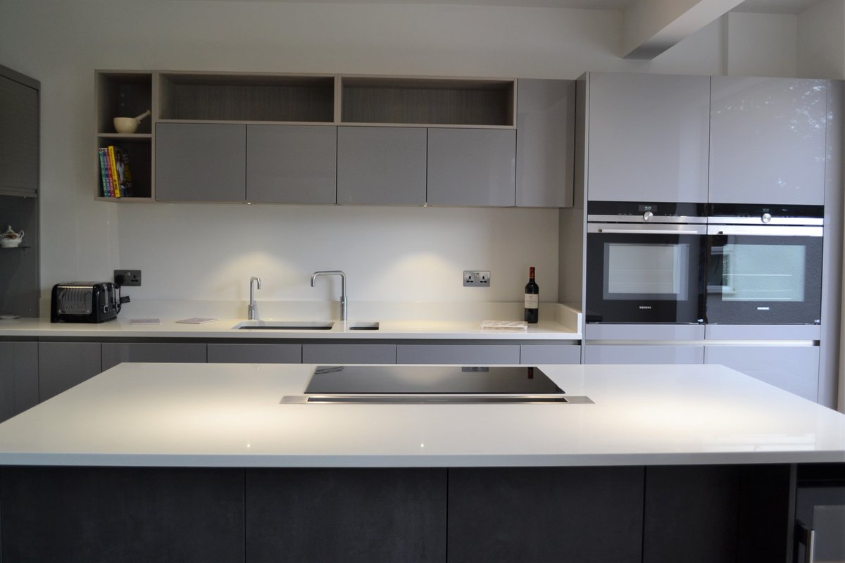 LaserGL, a high fashion grey decor and natural wood effect. This furniture collection features handleless cabinets and drawers, and provides a choice of ten finishes including a number of concrete and metallic styles.#bespokekitchens  #germankitchens #handlelesskitchens #worktops